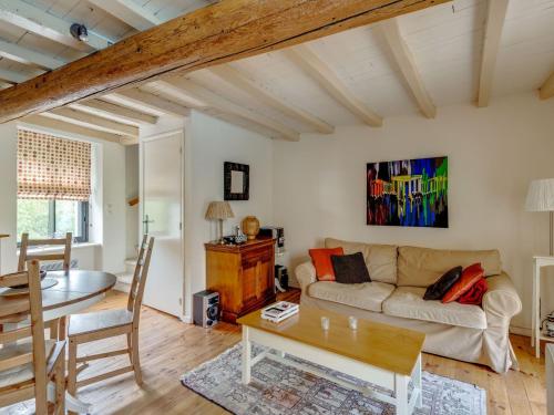 a living room with a couch and a table at Holiday home with pool in Cuxac Cabard s in Cuxac-Cabardès