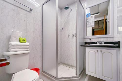 a bathroom with a shower and a toilet and a sink at Ayenda 1140 Roma Plaza in Manizales
