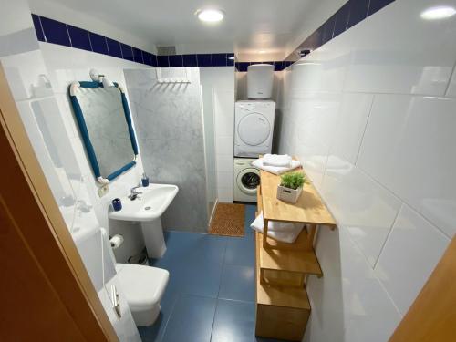 a white bathroom with a sink and a toilet at Ventana al roque apartamento con vistas al mar in Santa Cruz de Tenerife
