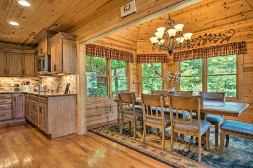 a kitchen and dining room with a table and chairs at Hayesville Cabin with Game Room and Mtn Views! in Hayesville