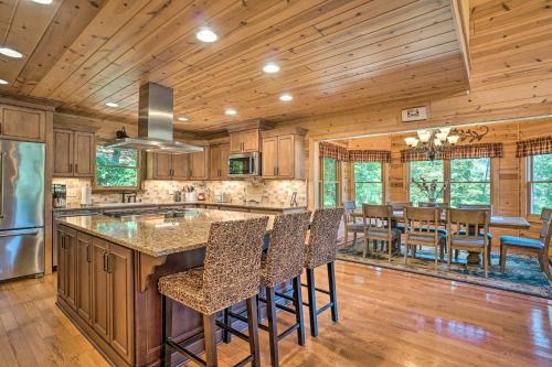an open kitchen with a large island with bar stools at Hayesville Cabin with Game Room and Mtn Views! in Hayesville