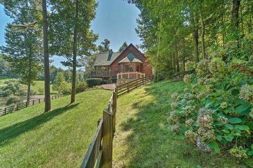 a wooden fence in front of a house at Hayesville Cabin with Game Room and Mtn Views! in Hayesville