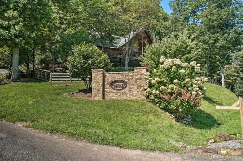 a sign in the grass next to a house at Hayesville Cabin with Game Room and Mtn Views! in Hayesville