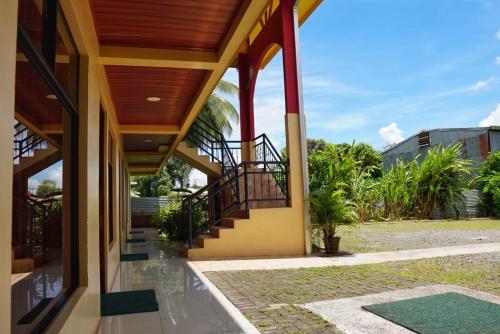 an external view of a house with a staircase at Hotel Heliconia Los Chiles in Los Chiles