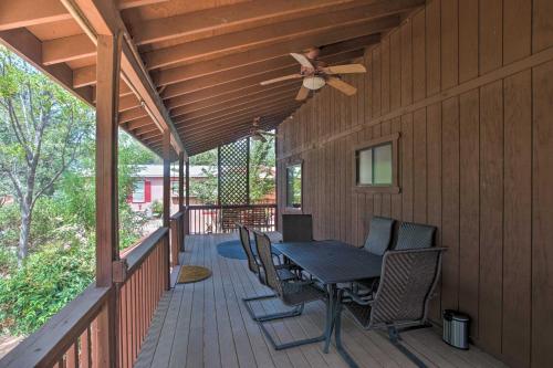 a wooden deck with a table and chairs and a ceiling fan at Near Golfing and Hiking Payson Family Cabin! in Payson