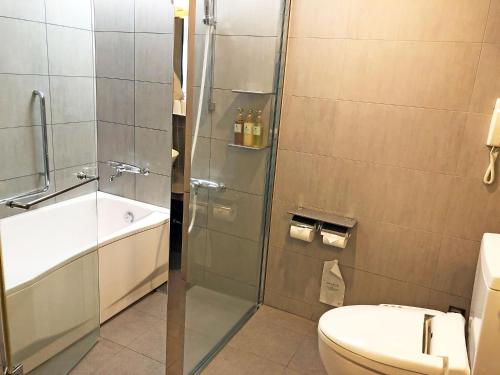 a bathroom with a shower and a toilet at Citadines Central Shinjuku Tokyo in Tokyo