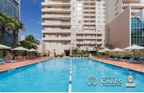 a swimming pool in front of a tall building at Somerset Chancellor Court Ho Chi Minh City in Ho Chi Minh City