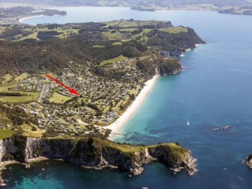 an aerial view of a small island with a beach at Hahei Beach House - 3 Bedroom in Hahei