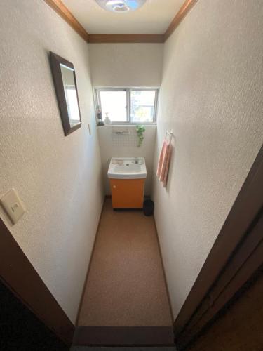 a small bathroom with a sink and a window at Shiga Biwa Lake Shanshui House in Takashima