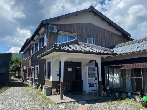 a house with the front door open on a street at Shiga Biwa Lake Shanshui House in Takashima