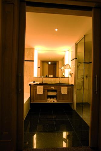 a bathroom with a sink and a mirror at Wellnesshotel Schönruh - Adults only in Seefeld in Tirol