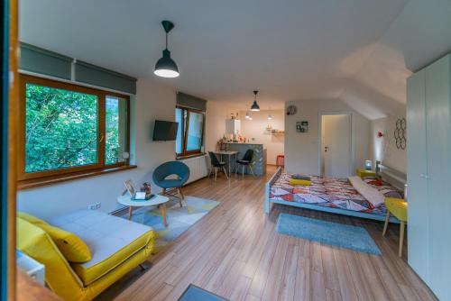 a living room with a couch and a table at Dragonfly Studio with GARDEN in Braşov