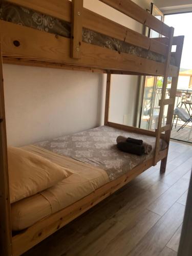 a bunk bed in a room next to a window at Casa di nonno sta in Santa Maria di Castellabate