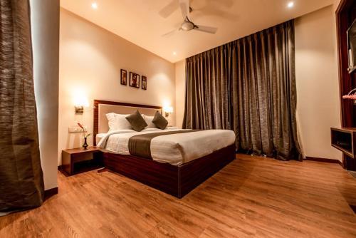 a bedroom with a bed and a large window at The Green Boutique in Panaji