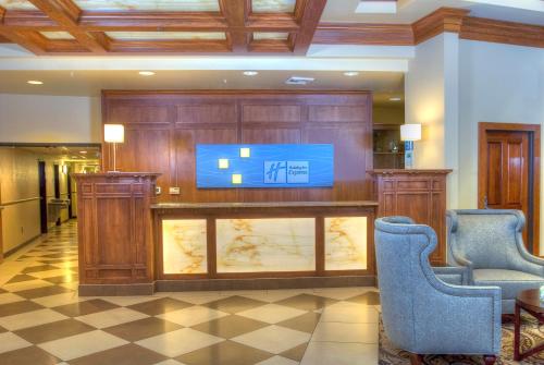 a hotel lobby with a reception desk with a flat screen tv at Holiday Inn Express Spokane-Downtown by IHG in Spokane