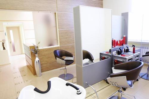 a salon with chairs and a sink and a mirror at Ukraine Hotel in Kyiv