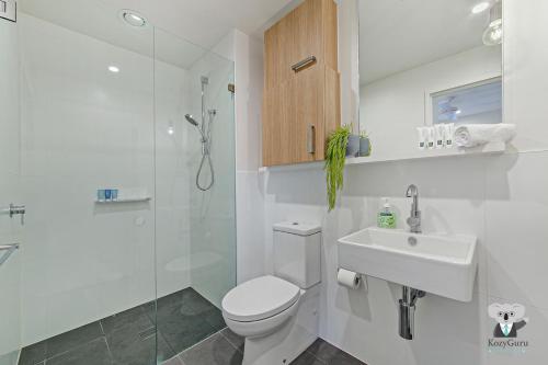a bathroom with a toilet and a sink and a shower at KOZYGURU WOLLI CREEK KOZY 1 BED APT SYDNEY AIRPORT & SYDNEY CBD NWC020 in Sydney