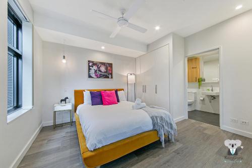 a bedroom with a large bed and a bathroom at KOZYGURU WOLLI CREEK KOZY 1 BED APT SYDNEY AIRPORT & SYDNEY CBD NWC020 in Sydney