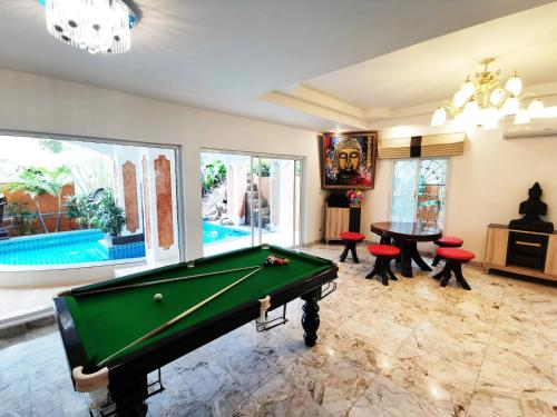 a pool table in a living room with a pool table at JOOPLAND Luxury Pool Villa Pattaya Walking Street in Pattaya South