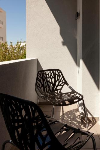 two chairs sitting on top of a balcony at STAY INN in Athens