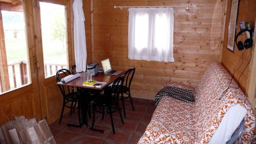 ハカにあるCamping Aín Jacaのデスク付きの客室とキャビン内のベッド1台を利用する客室です。