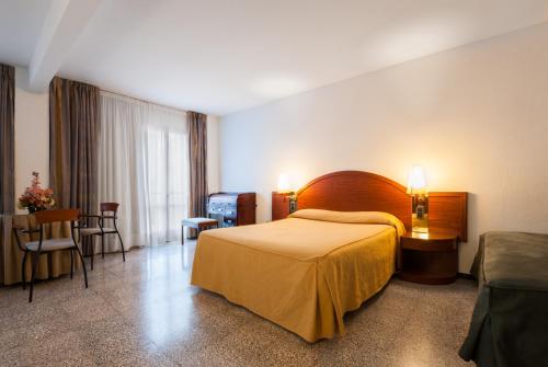 a hotel room with a bed and a table at Hotel Gaudi in Reus