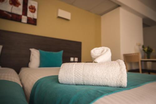 a pair of towels sitting on top of a bed at Sunseeker Holiday Complex in St Paul's Bay