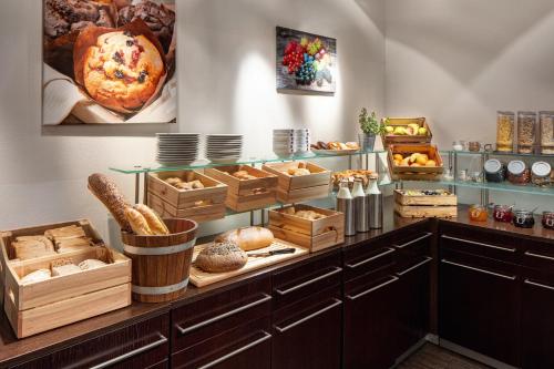 a kitchen filled with lots of different types of pastries at Clarion Hotel Prague City in Prague