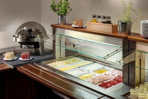 a display case in a restaurant with food at Clarion Hotel Prague City in Prague