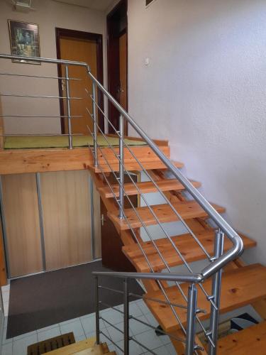 a staircase in a building with a metal railing at Apartmani Exit in Pale