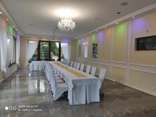 a conference room with a long table and white chairs at Hotel i Restauracja Admirał in Legnica