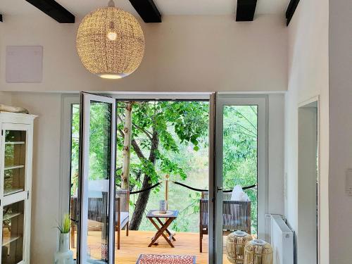 a pivot door in a living room with a view of a tree at Naabsuite in Neustadt an der Waldnaab