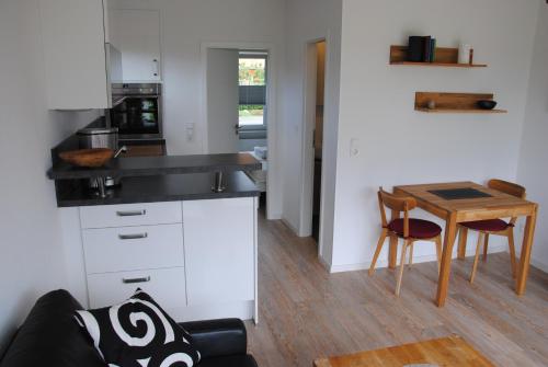 a kitchen with a couch and a table in a room at Ferienwohnung Wackerballig in Gelting