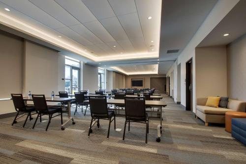 a conference room with tables and chairs and a couch at Hyatt House Oak Brook in Oak Brook