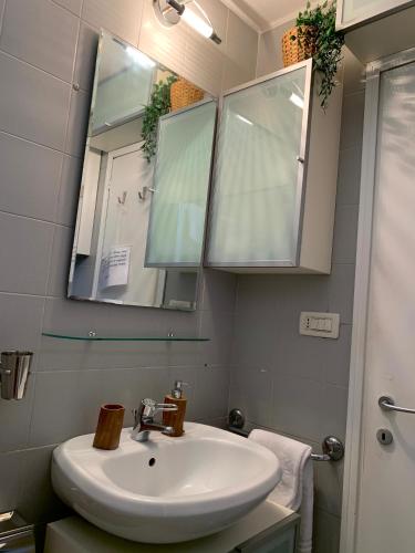 a bathroom with a sink and a mirror at REGINA - A cosy air conditioned studio just minutes from Rialto in Venice