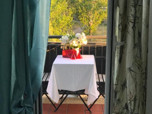 a table with a vase of flowers on a balcony at Costantino Home in Pompei