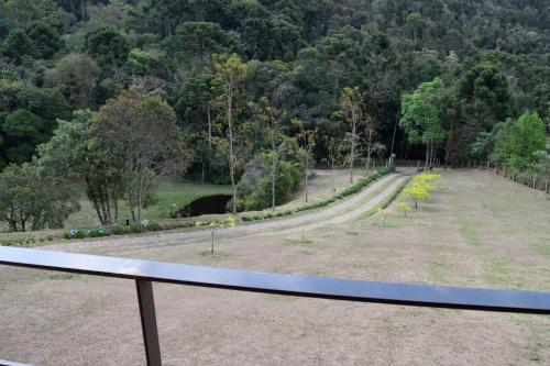 a view of a park with a road and trees at Chalés Boa Vista in Gonçalves