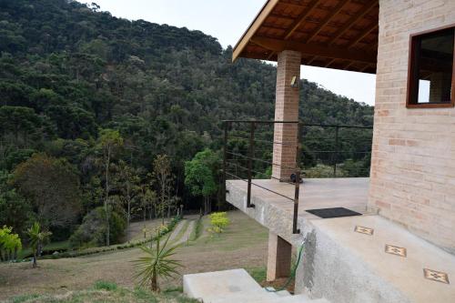 a balcony of a house with a view of a mountain at Chalés Boa Vista in Gonçalves