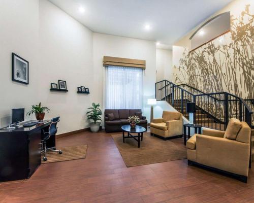 a living room filled with furniture and a staircase at Sleep Inn & Suites Guthrie - Edmond North in Guthrie