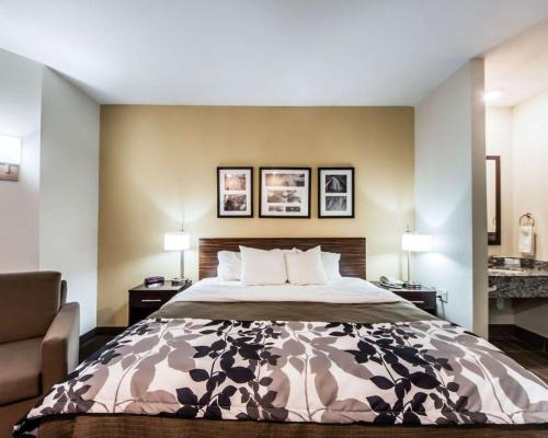 a hotel room with a bed and a chair at Sleep Inn & Suites Guthrie - Edmond North in Guthrie