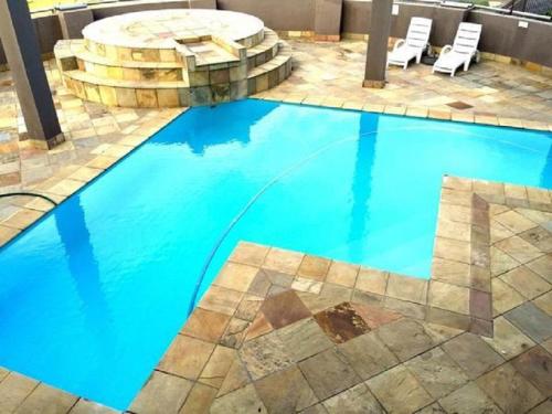 a large blue swimming pool with a fountain at Nautica 501 in Mossel Bay