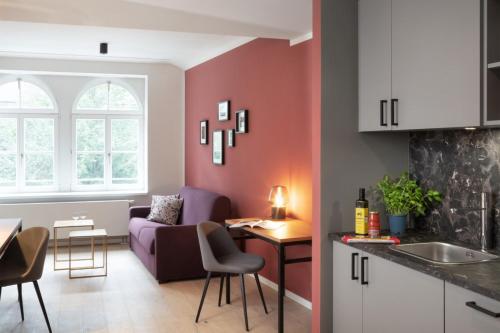 a kitchen and living room with a purple couch at Brera Leipzig in Leipzig