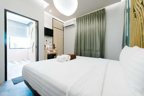 Un ou plusieurs lits dans un hébergement de l'établissement Samed Tropical Resort