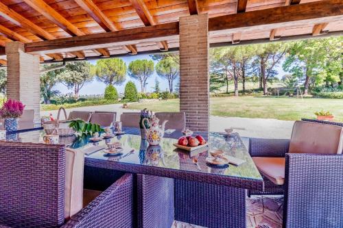 an outdoor dining area with a table and chairs at Gorgeous 2-storey villa with a large private pool in Todi