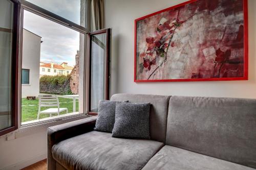 a living room with a couch and a large window at Cannaregio suite with garden in Venice