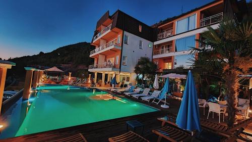 a swimming pool in front of a hotel at Villa Mina in Ohrid