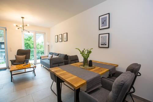 a living room with a table and a couch at Ahr-Palais in Altenahr