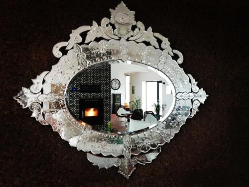 a mirror with a reflection of a living room at Monte Do Malhao - Art, Eco & Spa in Castro Marim