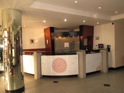 a lobby with a counter in a building at Hotel Luey in Buenos Aires
