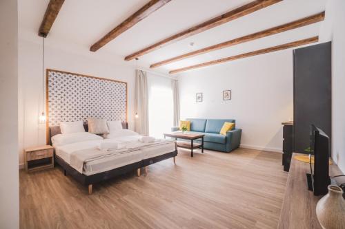 a large living room with a bed and a couch at Mathias Rex in Szentendre